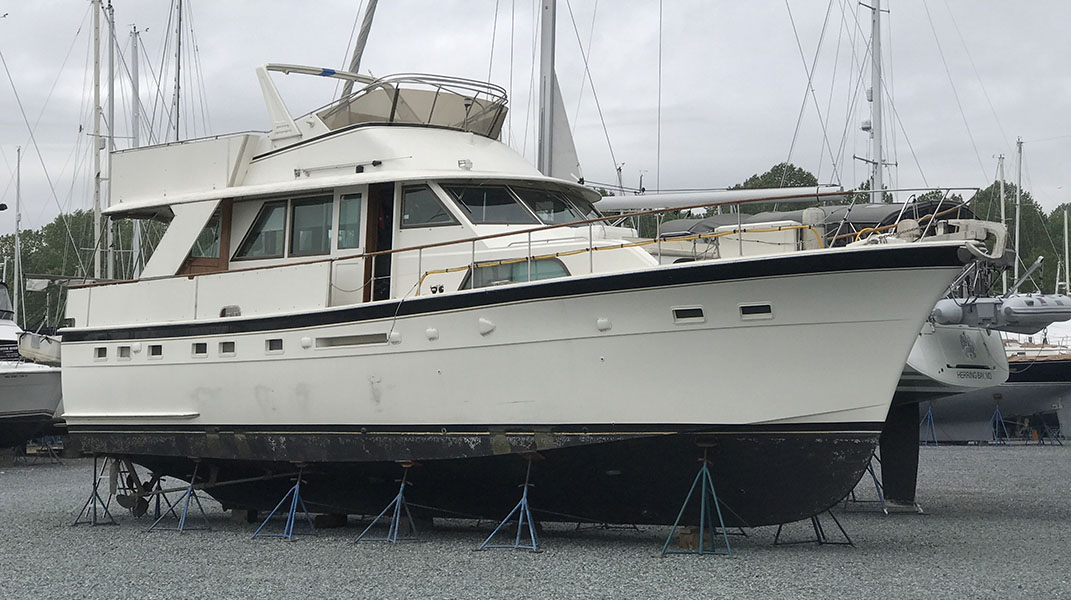 Photo of large motor yacht on blocks in a Boatyard.